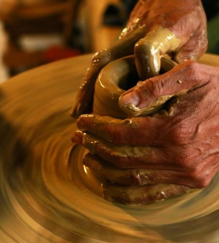 About Close-up of hands shaping clay on a pottery wheel, highlighting the art of ceramics, morocco ceramics.